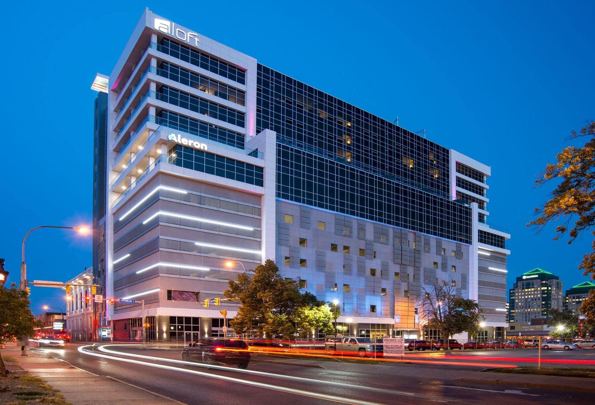 A precast building from a distance that's lit up at night