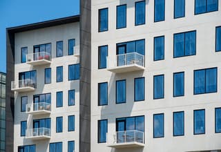 80 on the commons white framed back of building