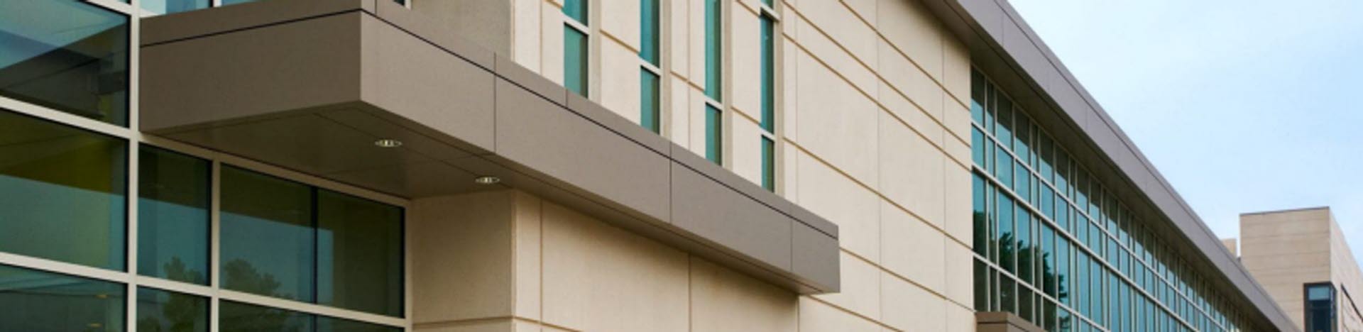 precast building with tan and brown walls and windows