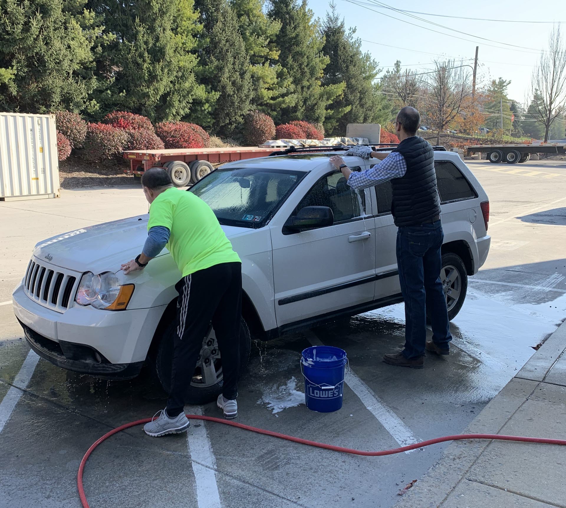 Leadership team participating in a car wash fundraiser