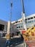 A crane on a construction site installing a precast concrete wall panel.