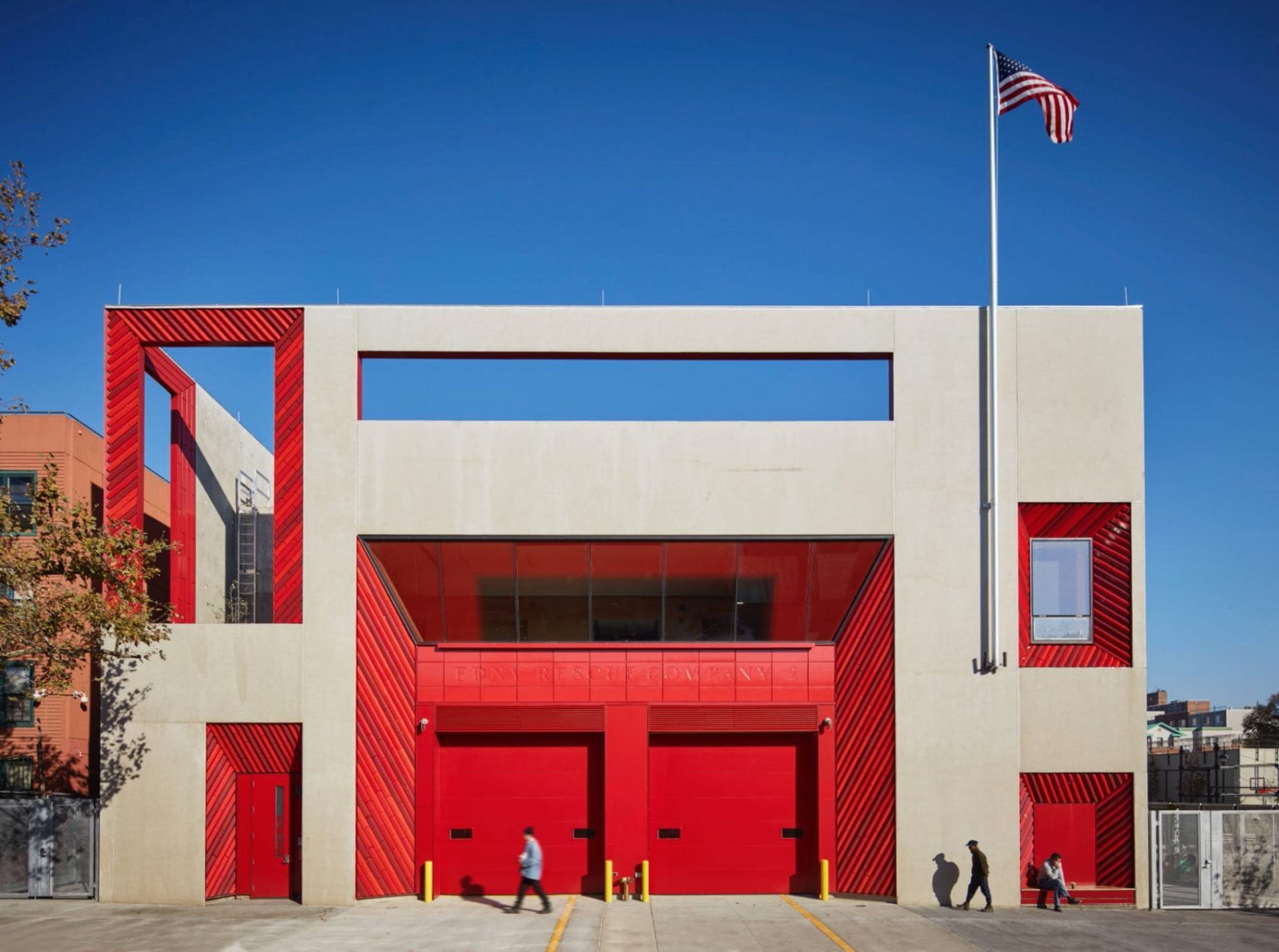 The outside view of a tan and red precast concrete structure