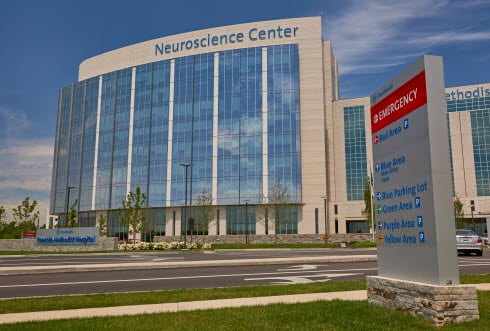 Front View of Riverside Neuroscience Center with Parking Sign