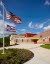 The world languages school with two flags on the lawn.