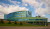 a precast concrete building with green tiles and lots of windows.